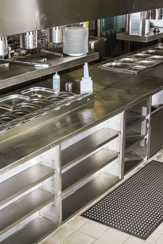 Insitu product image of black, natural rubber Safewalk Premium Mat in a commercial kitchen