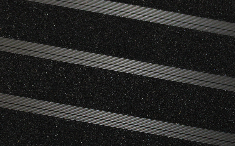 Close up image of Black Metro inserts in Black ARCHIMAT aluminium architectural matting