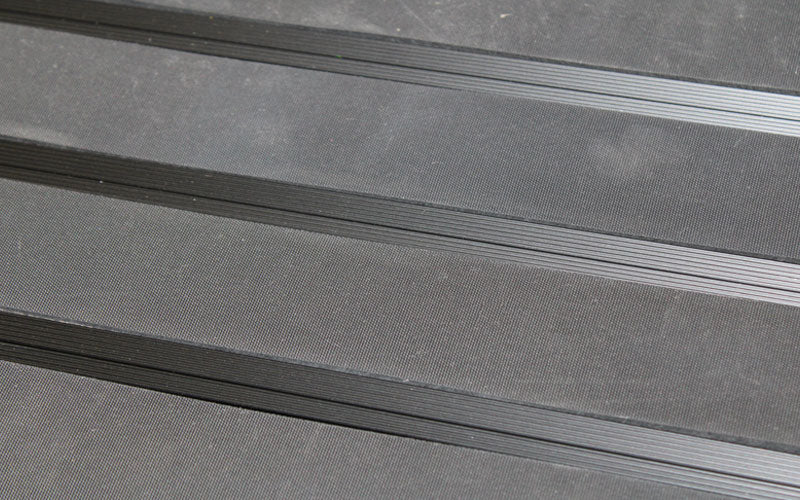 Close up image of Ply Insertion Rubber inserts in Black ARCHIMAT aluminium architectural matting