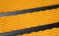 Close up image of Gold Superguard inserts in Black ARCHIMAT aluminium architectural matting