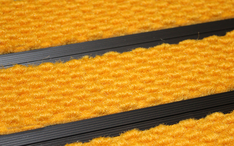 Close up image of Gold Superguard inserts in Black ARCHIMAT aluminium architectural matting