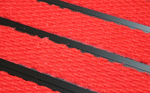 Close up image of Bright Red Superguard inserts in Black ARCHIMAT aluminium architectural matting