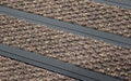 Close up image of Walnut Superguard inserts in Black ARCHIMAT aluminium architectural matting