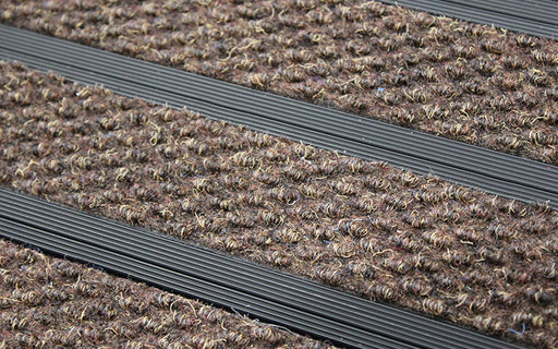 Close up image of Walnut Superguard inserts in Black ARCHIMAT aluminium architectural matting
