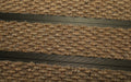 Close up image of Camel Superguard inserts in Bronze ARCHIMAT aluminium architectural matting