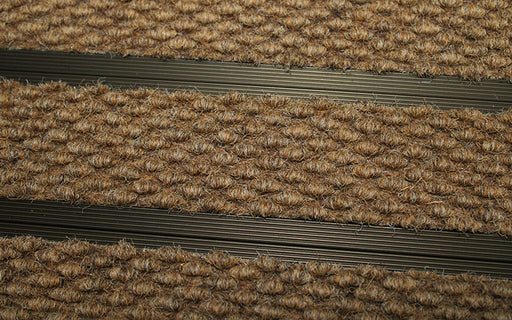 Close up image of Camel Superguard inserts in Bronze ARCHIMAT aluminium architectural matting