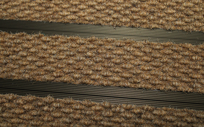 Close up image of Camel Superguard inserts in Bronze ARCHIMAT aluminium architectural matting