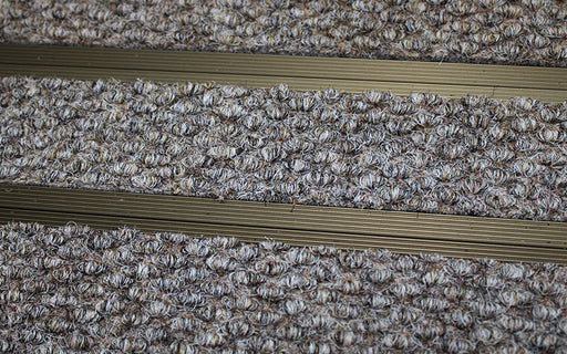 Close up image of Natural Beige Superguard inserts in Bronze ARCHIMAT aluminium architectural matting
