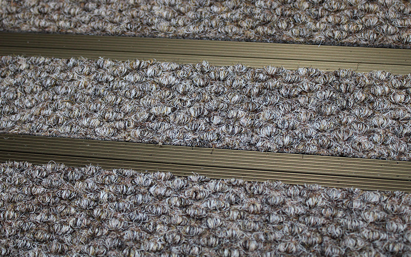 Close up image of Natural Beige Superguard inserts in Bronze ARCHIMAT aluminium architectural matting