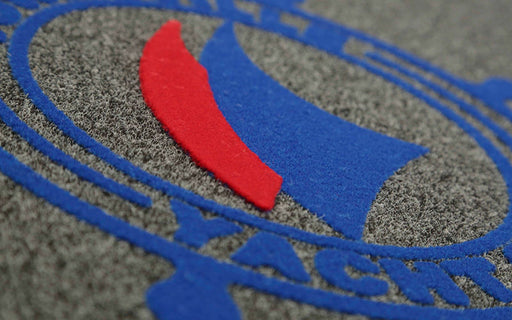 Close up product image of charcoal Dirtstopper Logo Mat with two colour print