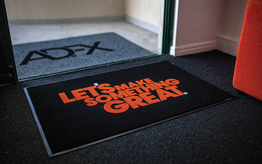 Insitu product image of black Dirtstopper Logo Mat with two colour print at office entrance