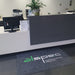 Insitu product image of charcoal Dirtstopper Logo Mat with two colour print at office reception