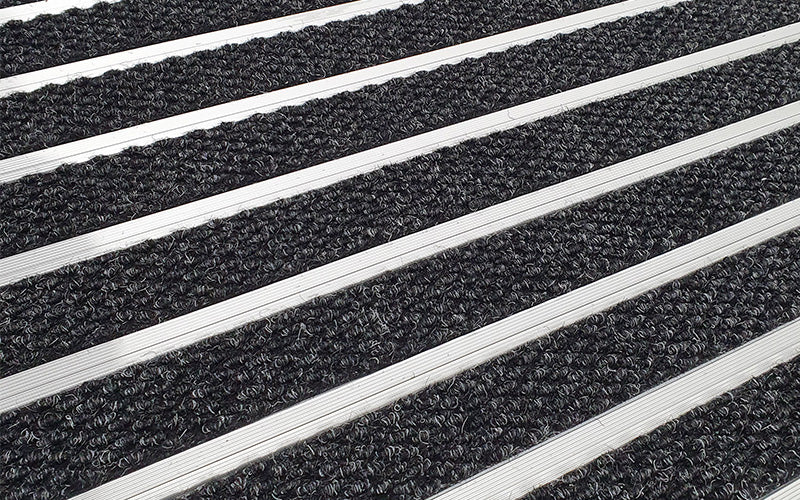 Close up image of Charcoal Superguard inserts in Silver ARCHIMAT aluminium architectural matting