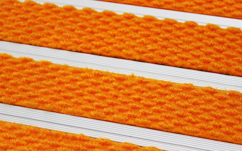 Close up image of Orange Superguard inserts in Silver ARCHIMAT aluminium architectural matting