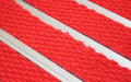 Close up image of Bright Red Superguard inserts in Silver ARCHIMAT aluminium architectural matting