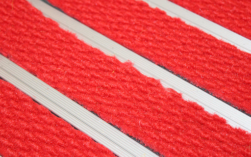 Close up image of Bright Red Superguard inserts in Silver ARCHIMAT aluminium architectural matting