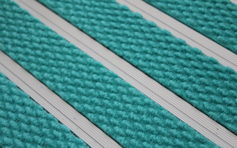 Close up image of Turquoise Superguard inserts in Silver ARCHIMAT aluminium architectural matting