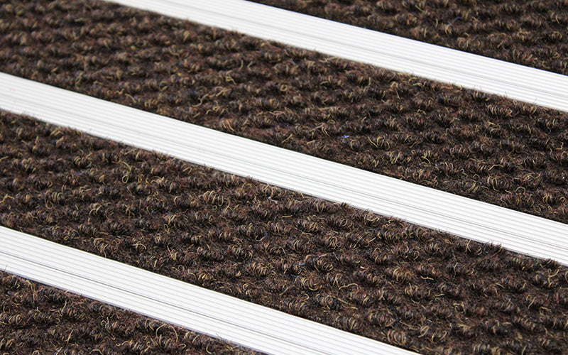Close up image of Walnut Superguard inserts in Silver ARCHIMAT aluminium architectural matting