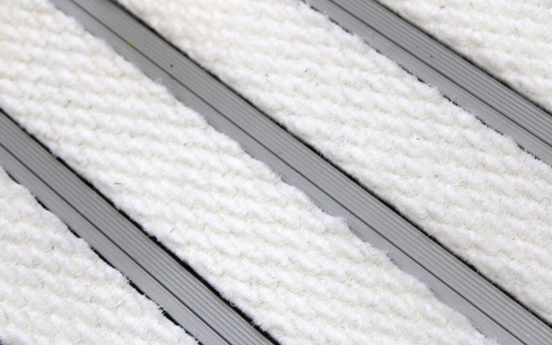 Close up image of White Superguard inserts in Silver ARCHIMAT aluminium architectural matting