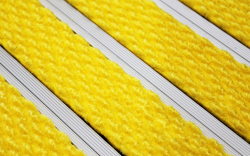 Close up image of Yellow Superguard inserts in Silver ARCHIMAT aluminium architectural matting