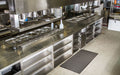 Insitu product image of black, natural rubber Safewalk Premium Mat in a commercial kitchen