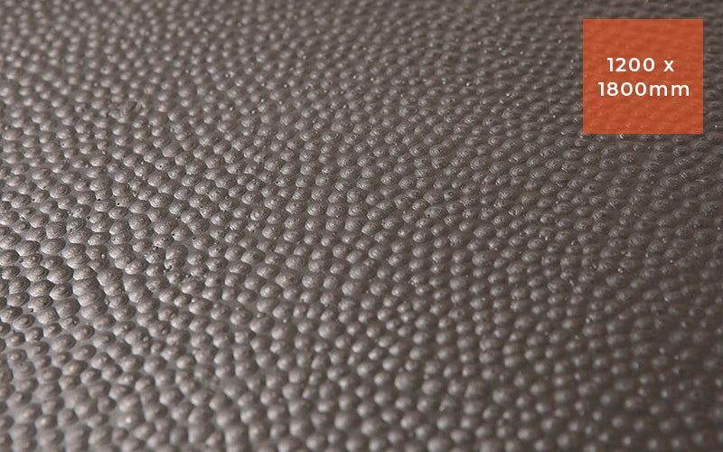 Close up product image of black rubber stable mat with hammertop surface