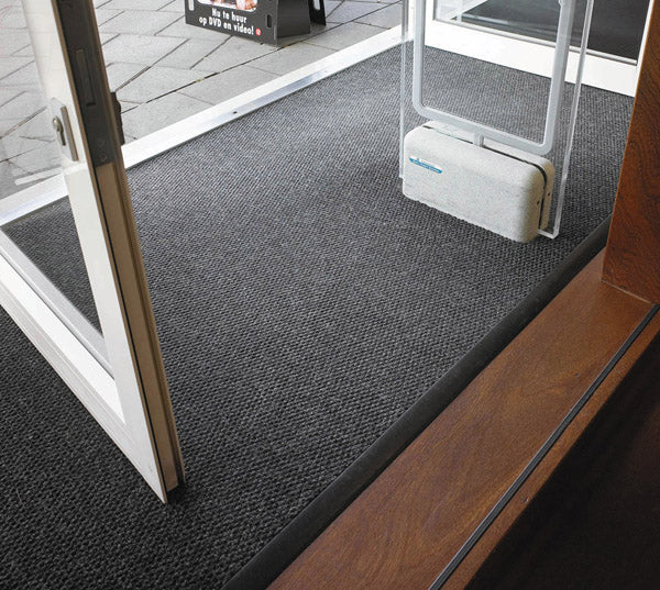 Insitu image of the superguard charcoal entrance mat installed into entry doors with security scanners.