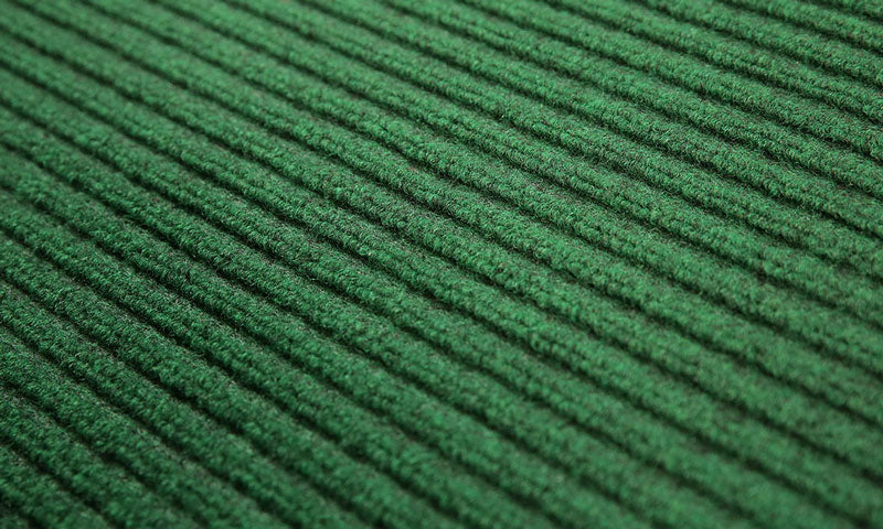 Close up product image of green, polypropylene Tough Rib Mat made for commercial and residential entrances