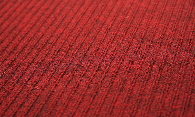 Close up product image of red, polypropylene Tough Rib Mat made for commercial and residential entrances