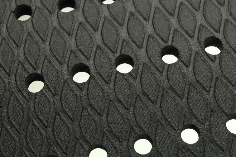 Close up image of the drainage holes for moisture and debris in the cushion max mat with holes.