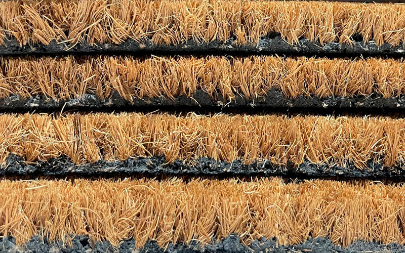 Close up side view of the latex that is on the back of the coir doormat