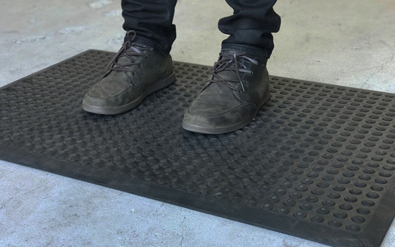 Insitu product image of anti-fatigue, black, rubber Supreme Comfort Mat in industrial setting