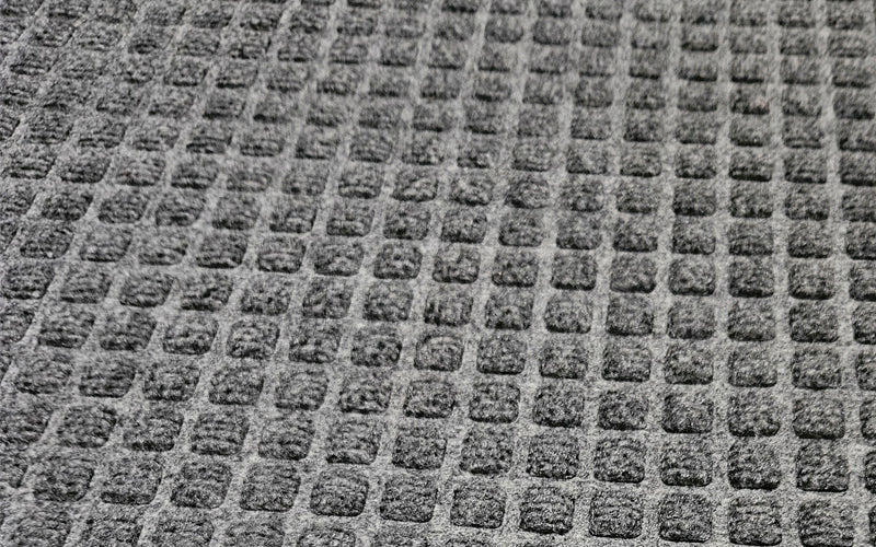 Close up image of the small repeated carpet pattern that is stain and fade resistant  