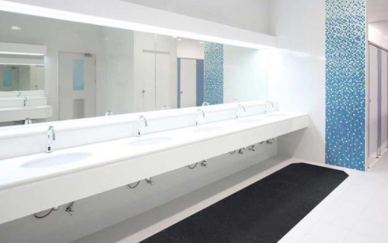 Insitu product image of black, non-slip SmartGrip Matting in a public restroom