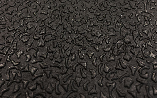 Close up product image of black rubber stable mat with bark surface