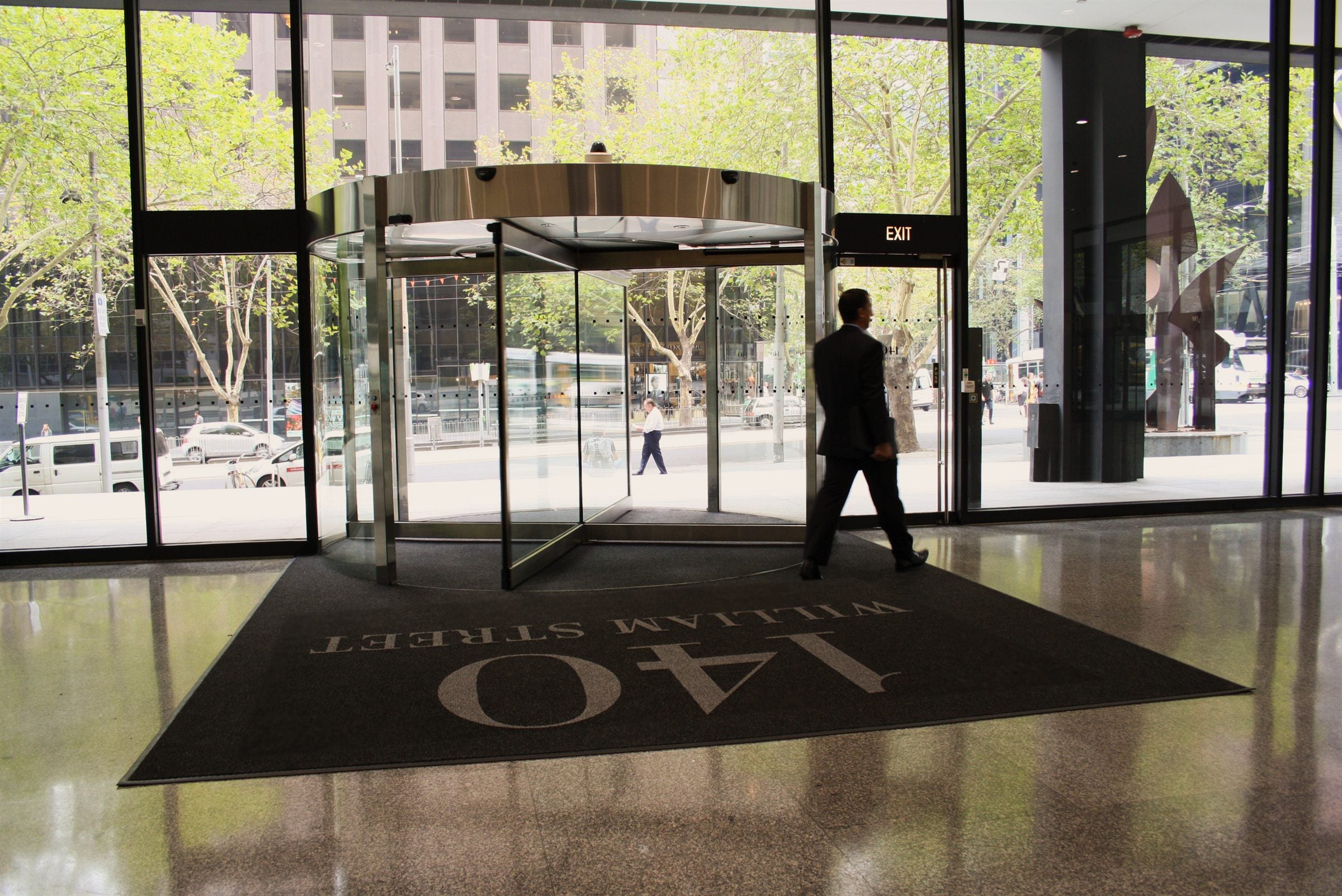 Superguard Logo Inlay entrance mat branded 140 William Street, installed at a commercial revolving door entrance